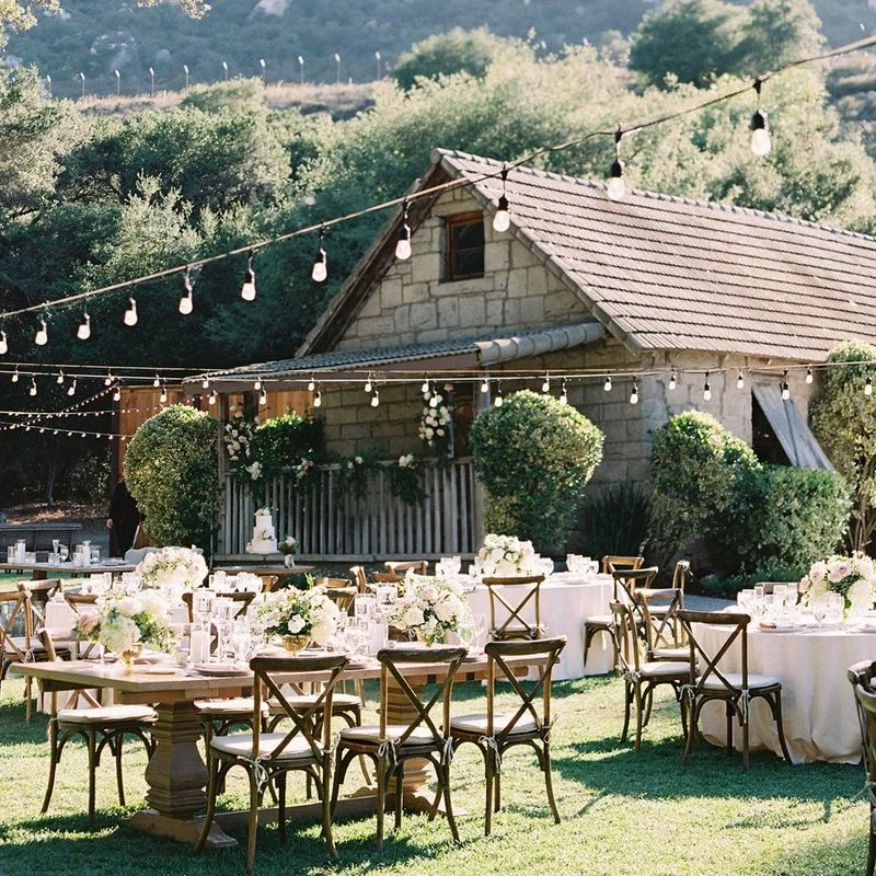 The rustic stone house and garden reception space at the venue